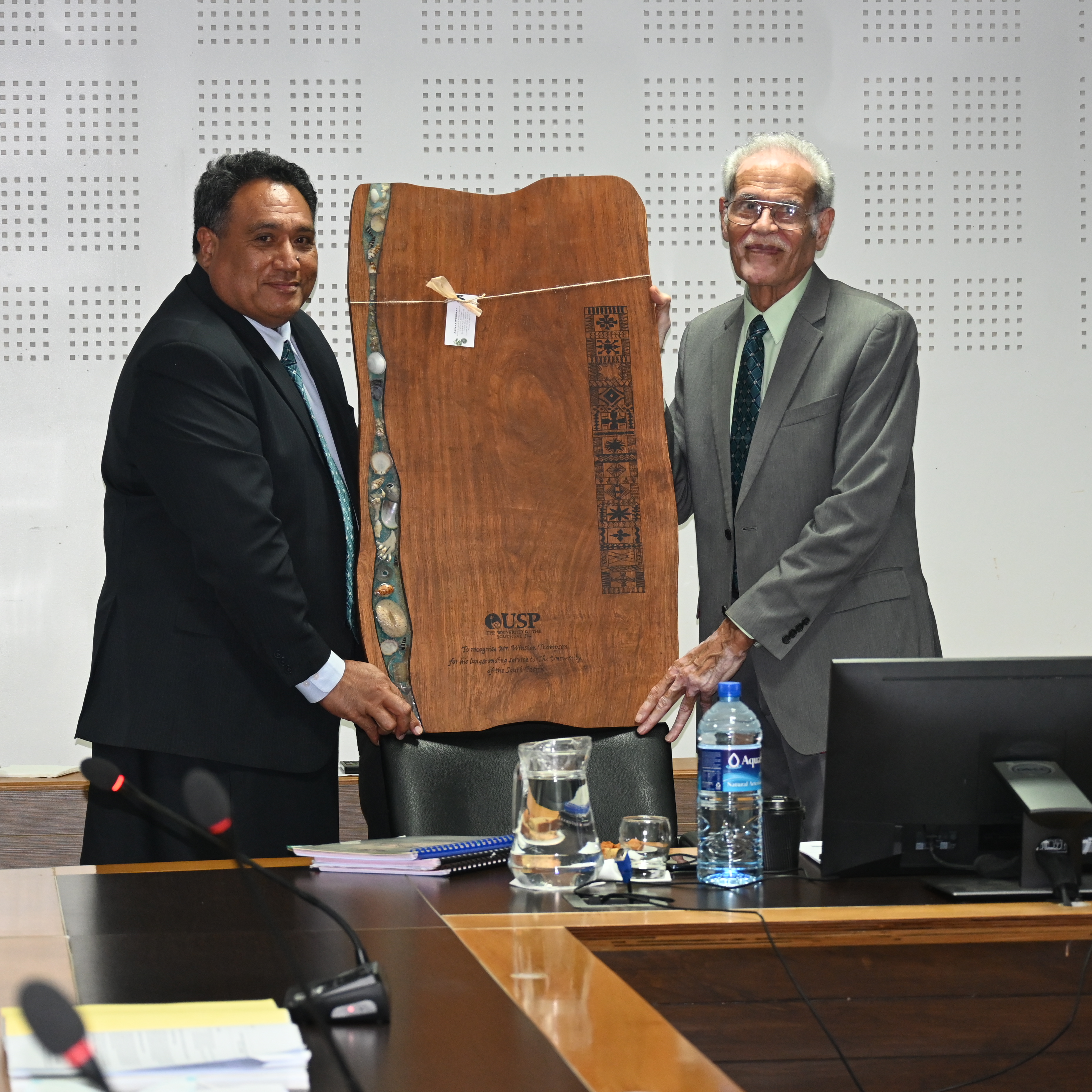 Outgoing Pro-Chancellor and Chair of Council, Mr Winston Thompson receives the plauque from Deputy Vice-Chancellor, Dr. Giulio Paunga during the 92nd USP Council Meeting