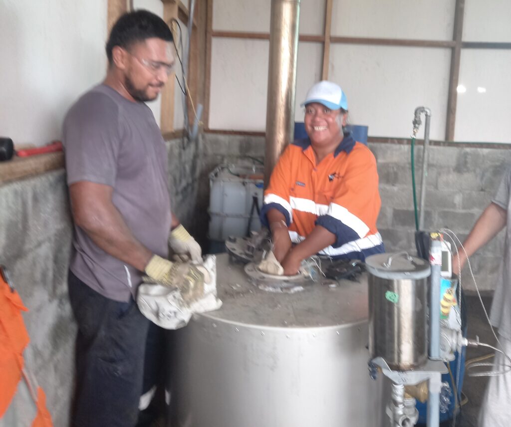Miriama and Jo filling the pyrolysis reactor with waste plastics