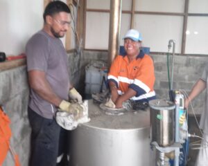 Miriama and Jo filling the pyrolysis reactor with waste plastics