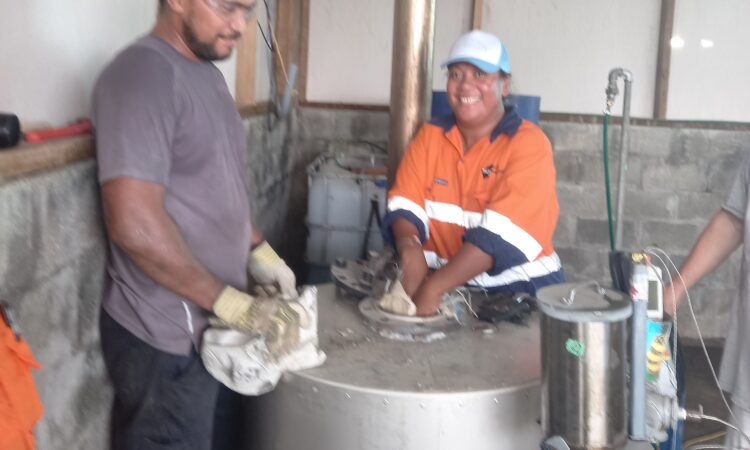 Miriama and Jo filling the pyrolysis reactor with waste plastics